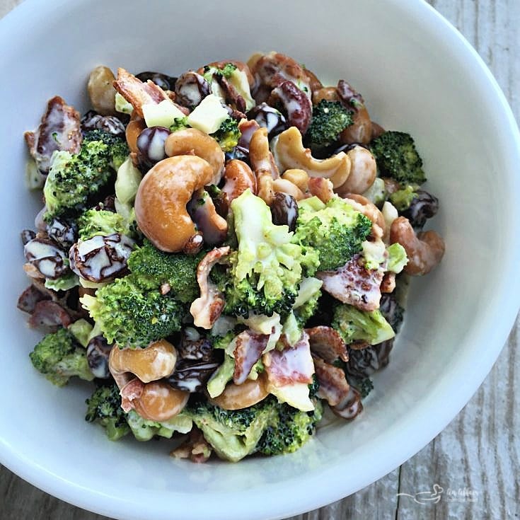 Top view bacon cashew broccoli salad in white bowl