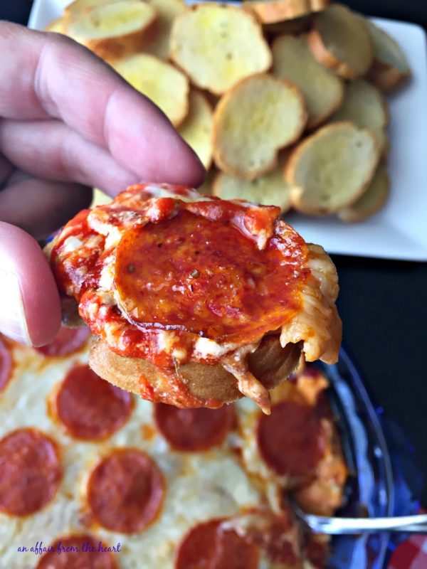 Enjoy this warm and cheesy Pepperoni Pizza Dip perfect for tailgating!