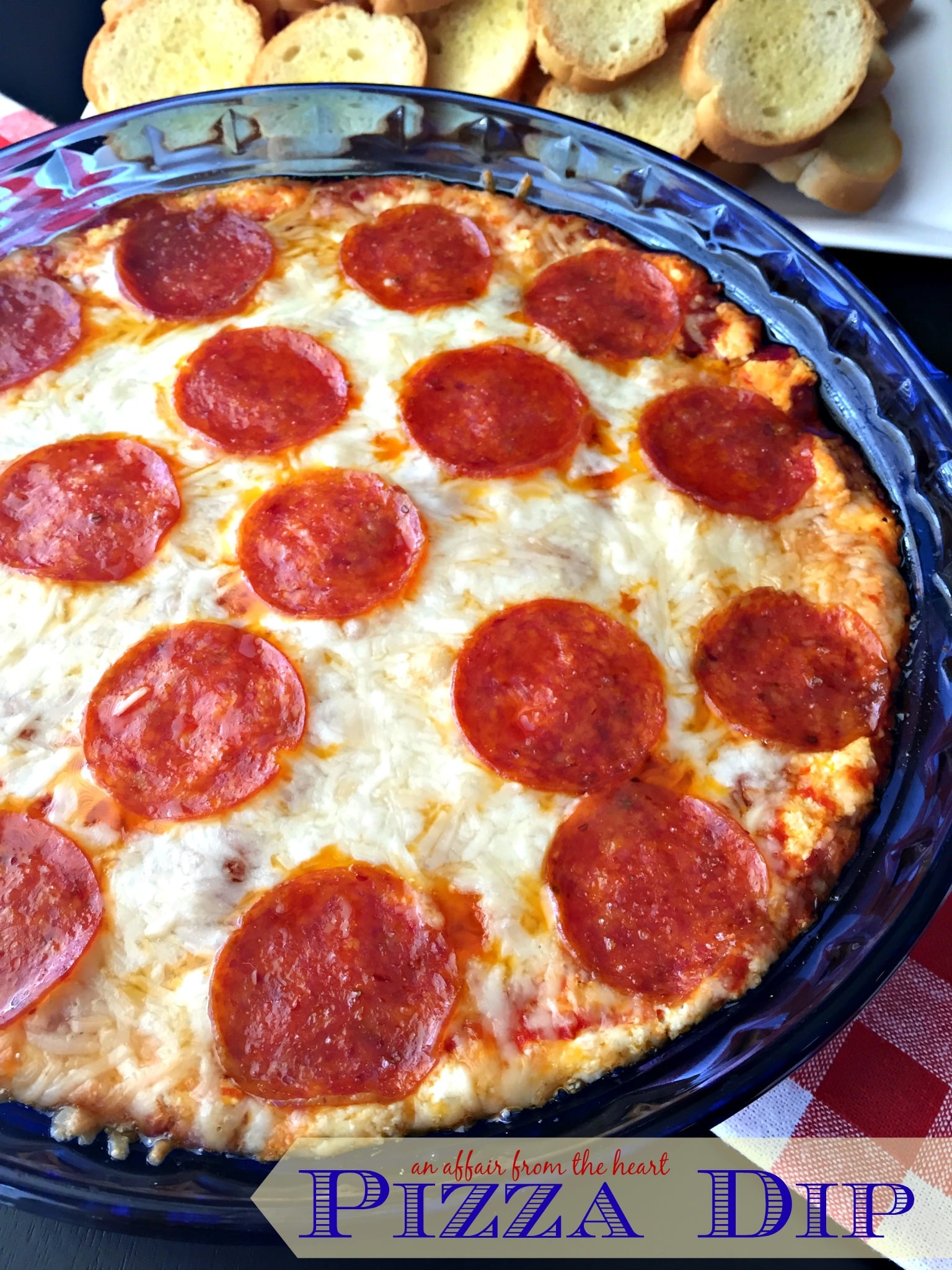 Enjoy this warm and cheesy Pepperoni Pizza Dip perfect for tailgating!