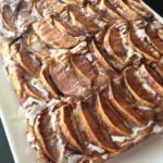 Apple Kuchen (German Apple Cake) on a white serving plate
