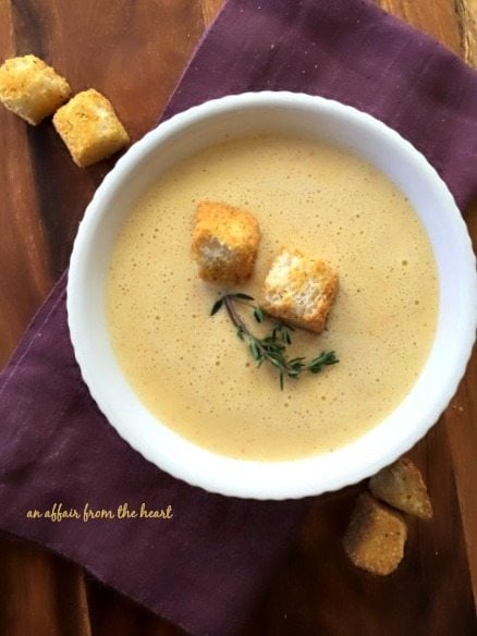 overhead of 1886 Cafe & Bakery Cheese Soup in a white bowl