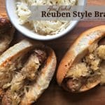 overhead of 3 brats and a bowl of kraut with text "Slow Cooked Reuben Style Brats"