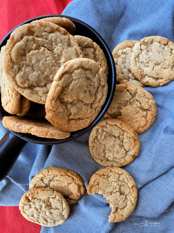 overhead of butter brickle cookies in a bowl and on a table