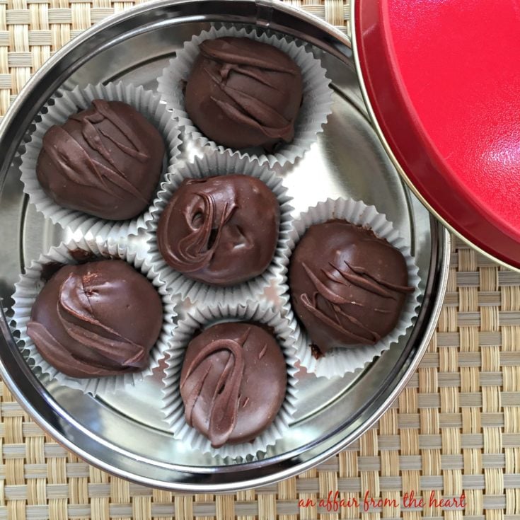overhead of Peanut Butter Chocolate Chip Cookie Dough Truffles in a candy tin