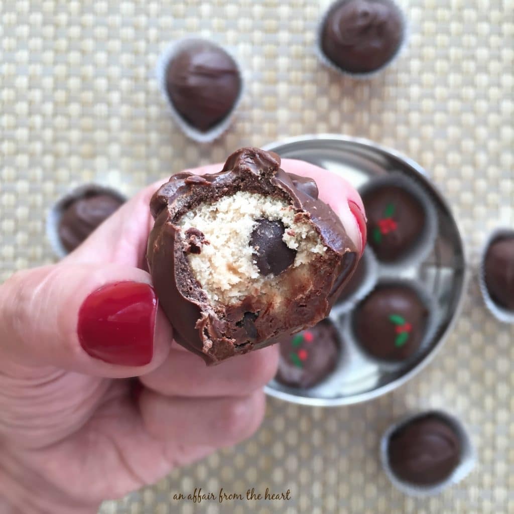 close up of a Peanut Butter Chocolate Chip Cookie Dough Truffle with a bite out of it