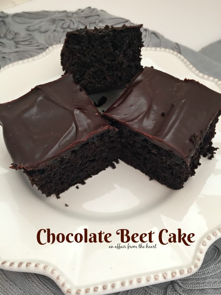 Close up of cake on a white serving plate with text "Chocolate Beet Cake"