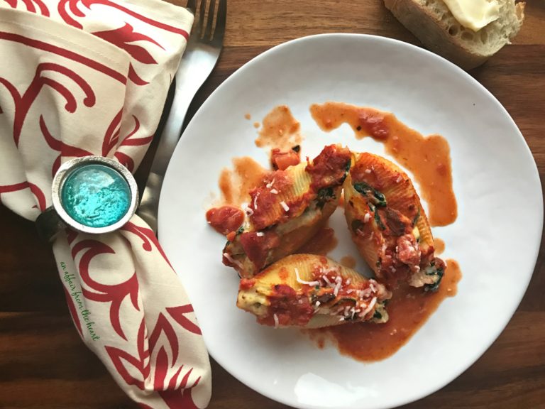 overhead of Spinach & Artichoke Stuffed Shells on a white plate