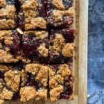 PB&J Oatmeal Cookie Bars cut into squares on a wooden board