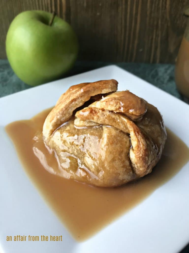 Close up of Apple Dumpling with spiced rum caramel sauce on a white plate