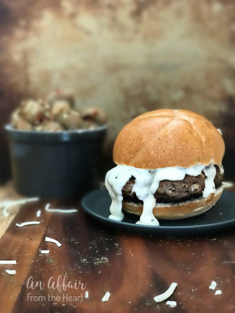 Green Chile Mushroom Burger with Monterey Jack Cheese Sauce on a blue plate