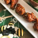 Close up of Honey Sriracha Wings on a white plate
