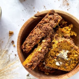 Pumpkin Zucchini Streusel Bread slices in a brown bowl