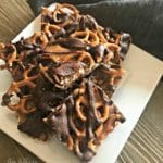 Salted Caramel Chocolate Pretzel Bars stacked on a white plate