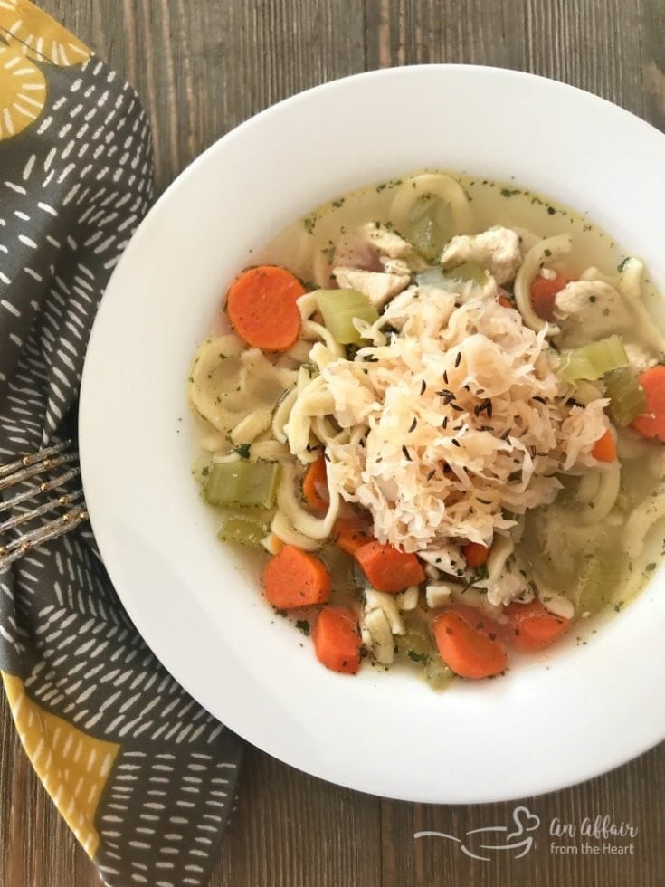 Chicken Noodle Soup with Sauerkraut in a white bowl