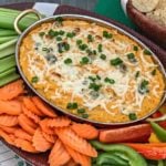 Buffalo Cauliflower Dip surrounded by a variety of vegetables for dipping