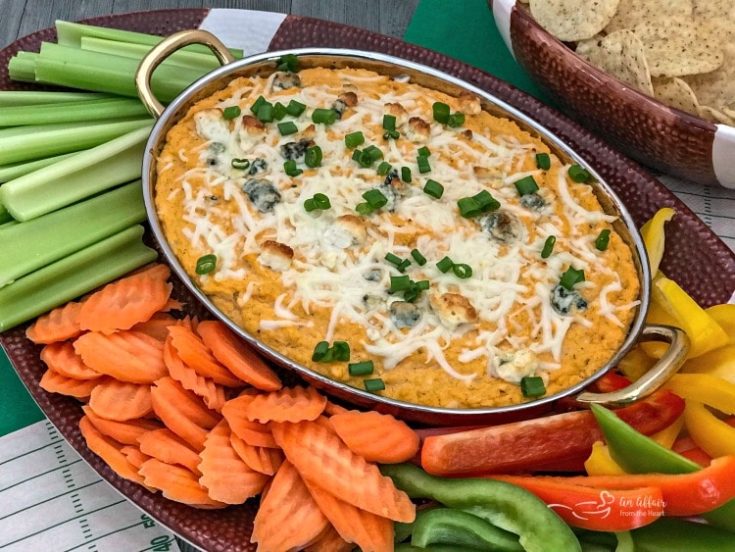 Buffalo Cauliflower Dip surrounded by a variety of vegetables for dipping