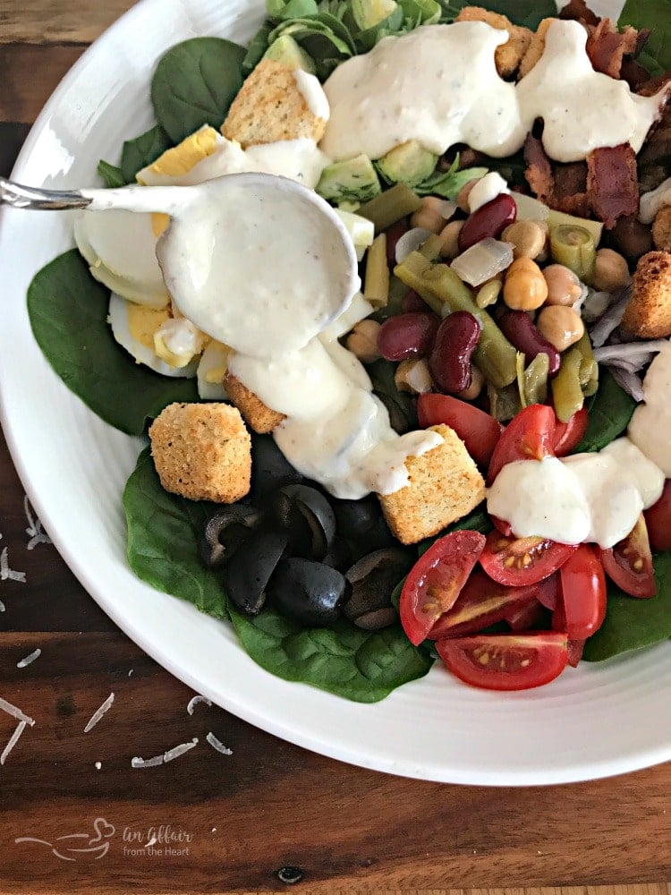 Loaded Spinach Salad with Creamy Roasted Garlic Dressing prep