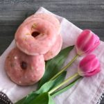Overhead of Cherry Limeade Baked Donuts and tulips on a white cloth napkin