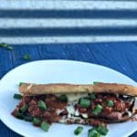 Spicy-Grilled-Cheese-Chili-Dog on a white plate