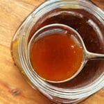 A full serving spoon of delicious honey bourbon sauce