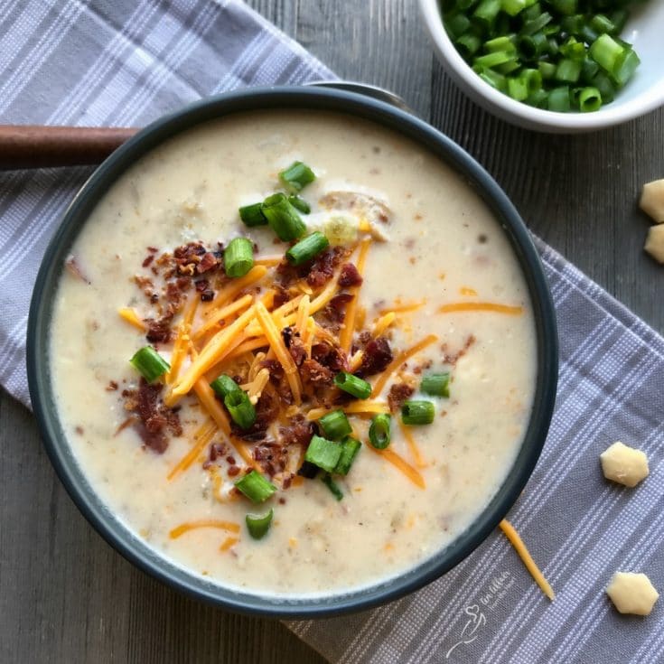 close up of Loaded Potato Soup in a dark bowl