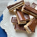 Homemade Twix Bars stacked on a white serving plate