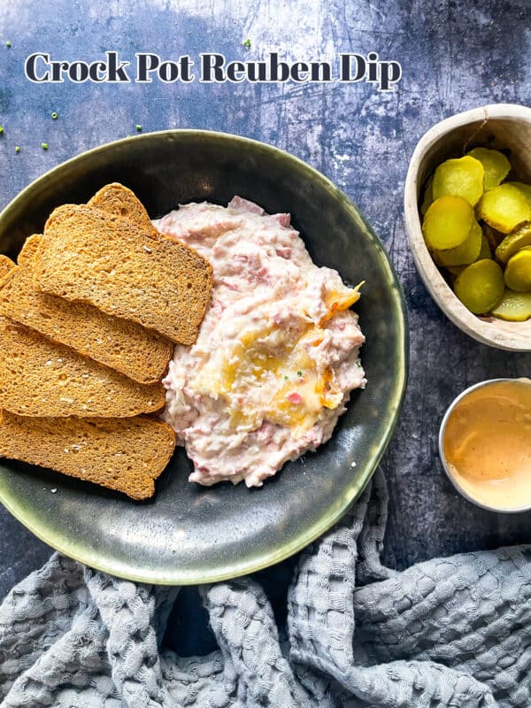 Reuben dip and rye toast in a green bowl.