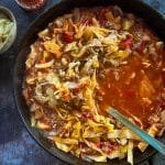 spooning out cabbage roll soup from the skillet