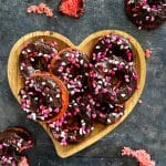 Chocolate Covered Strawberry Donuts stacked in a hearty shaped platter.