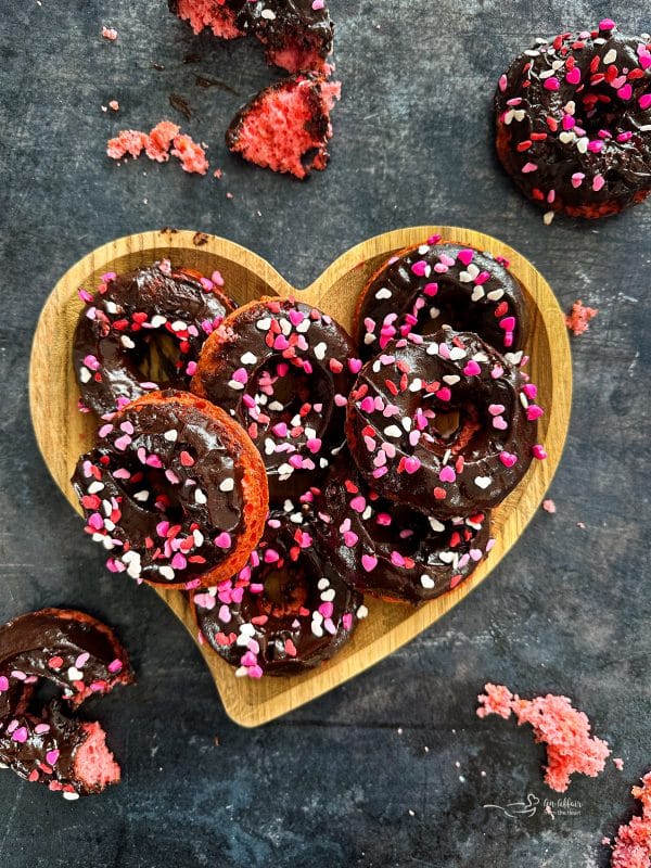 Chocolate Covered Strawberry Donuts stacked in a hearty shaped platter.