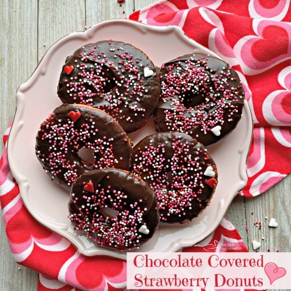 overhead of Baked Chocolate Covered Strawberry Donuts on a pink plate and text "chocolate covered strawberry donuts"