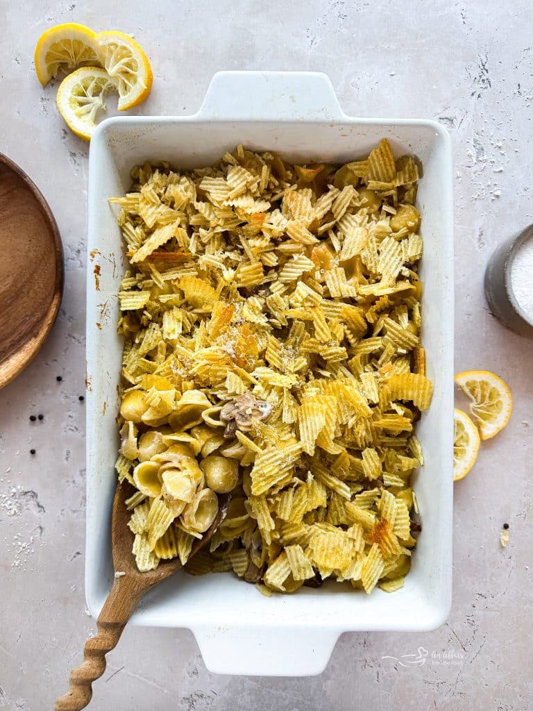 Scooping the Tuna Tetrazzini out of the casserole dish.