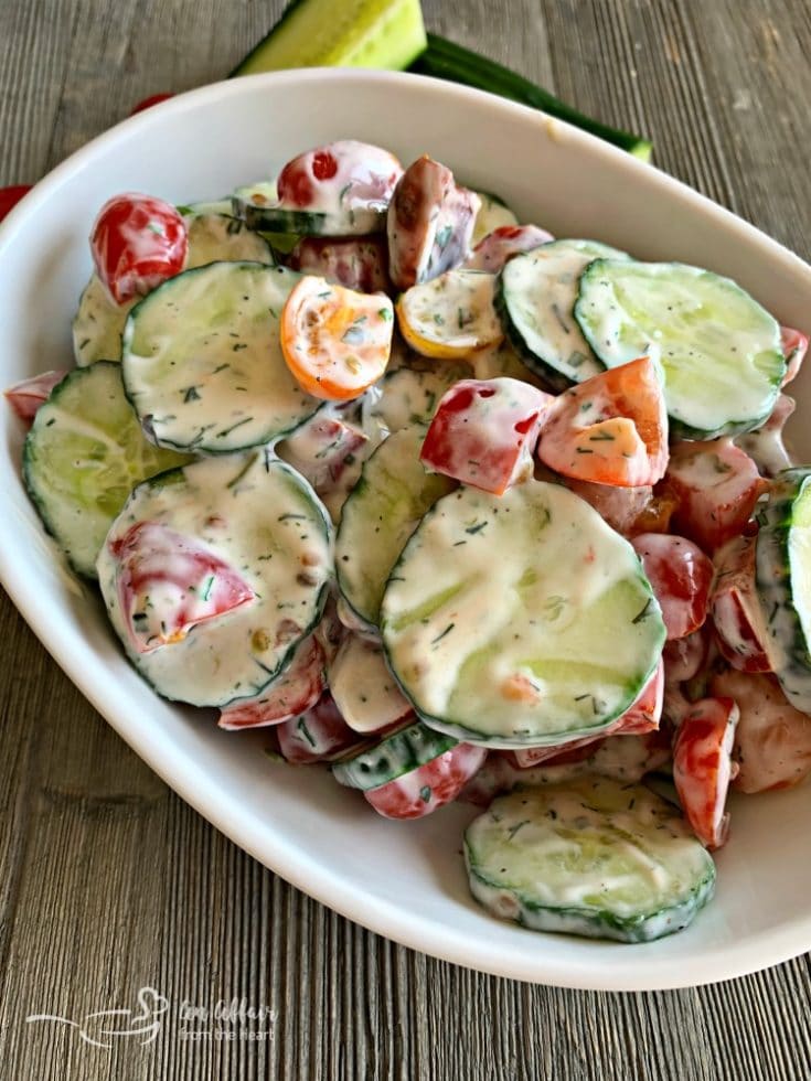 Overhead of Cucumber & Tomato Salad with Yogurt Dressing in a white serving dish
