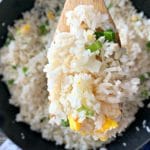 Close up of Homemade Basic Garlic Fried Rice on a wooden spoon