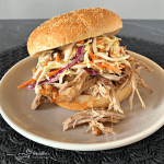Close up of Crock Pot Pulled Pork with Dorothy Lynch Coleslaw on a white plate