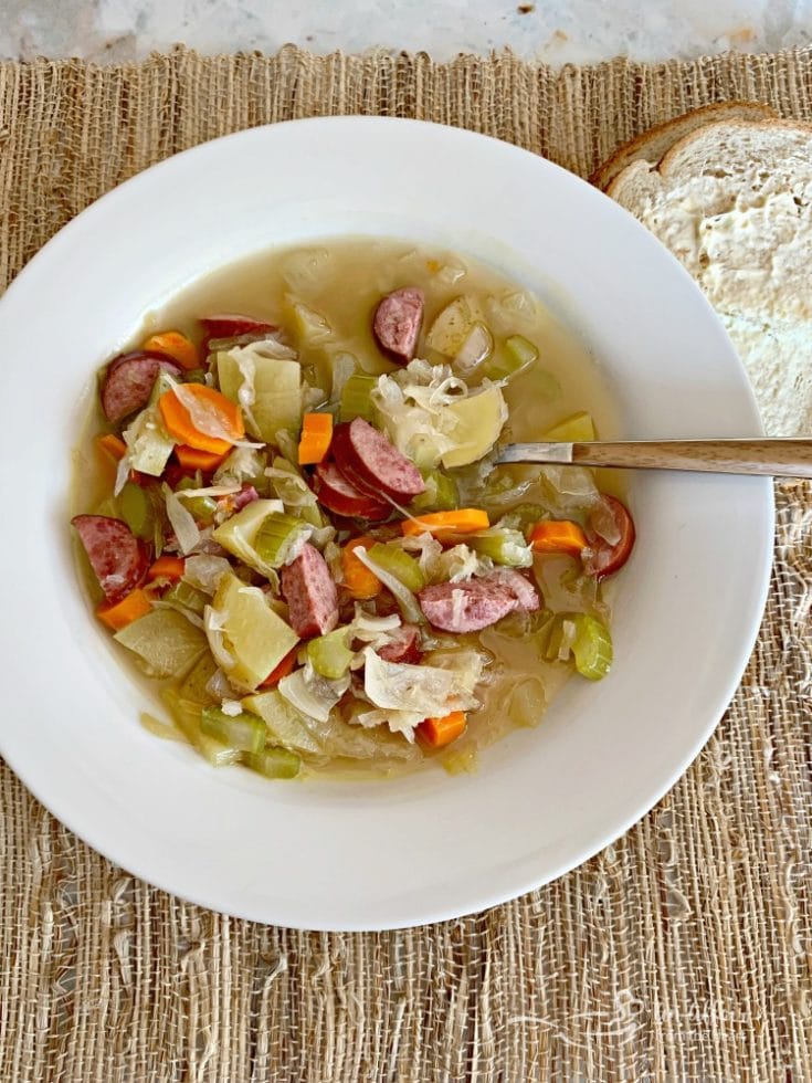 Overhead of Polish Sauerkraut Soup - Kapusniak in a white bowl