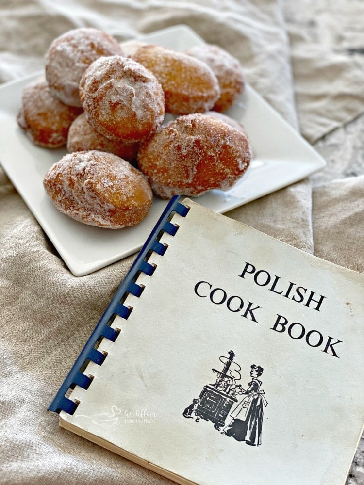 Pączki - Polish Donuts on a white plate and Polish Cookbook