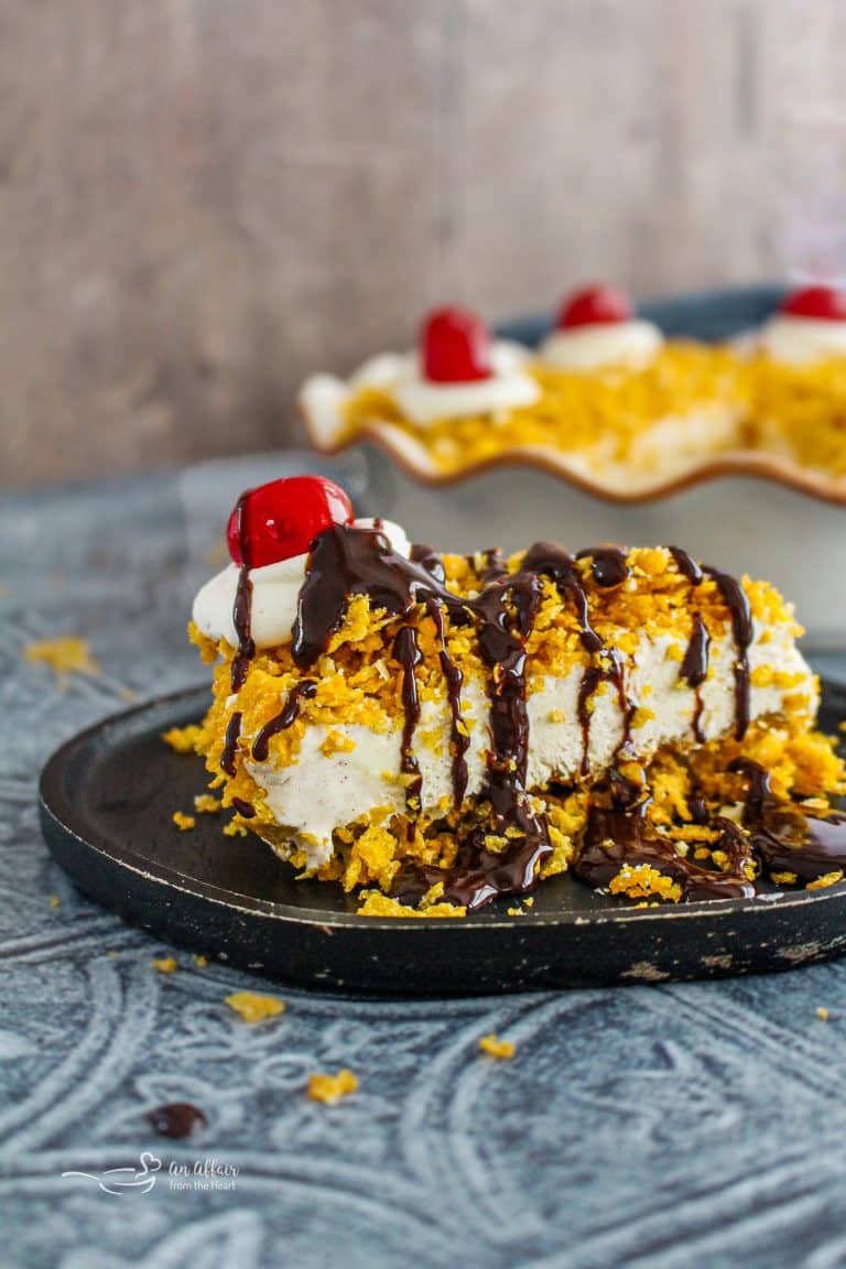 A Slice of Fried Ice Cream Pie topped with chocolate syrup, whipped cream and a cherry.