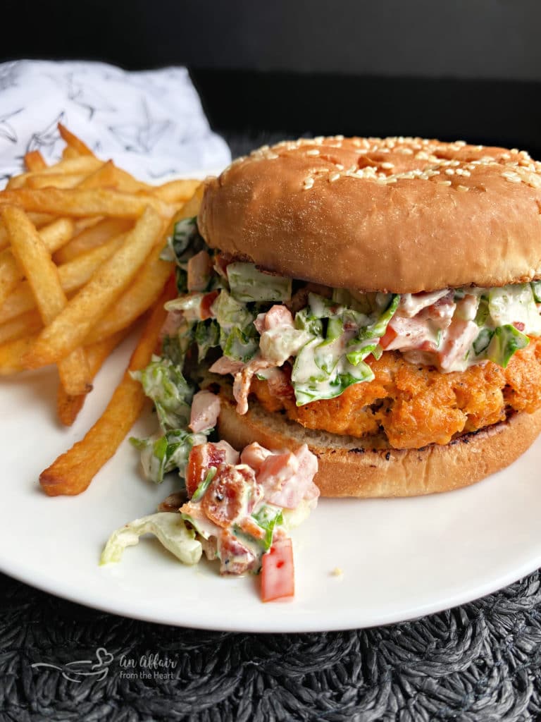 Blackened Salmon Burgers with BLT Slaw with fries on white plate