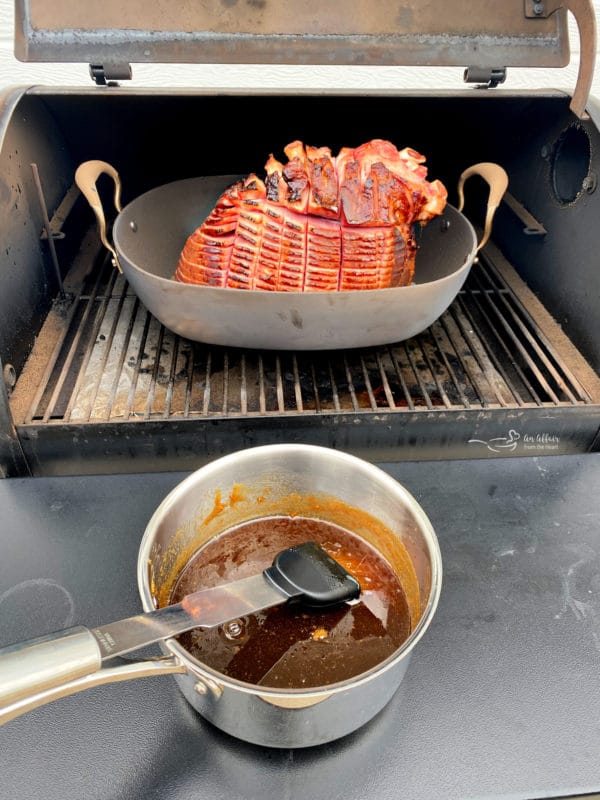 Glazing a smoked ham on the traeger