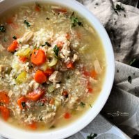 Close up of Instant Pot Chicken & Rice Soup in a white bowl