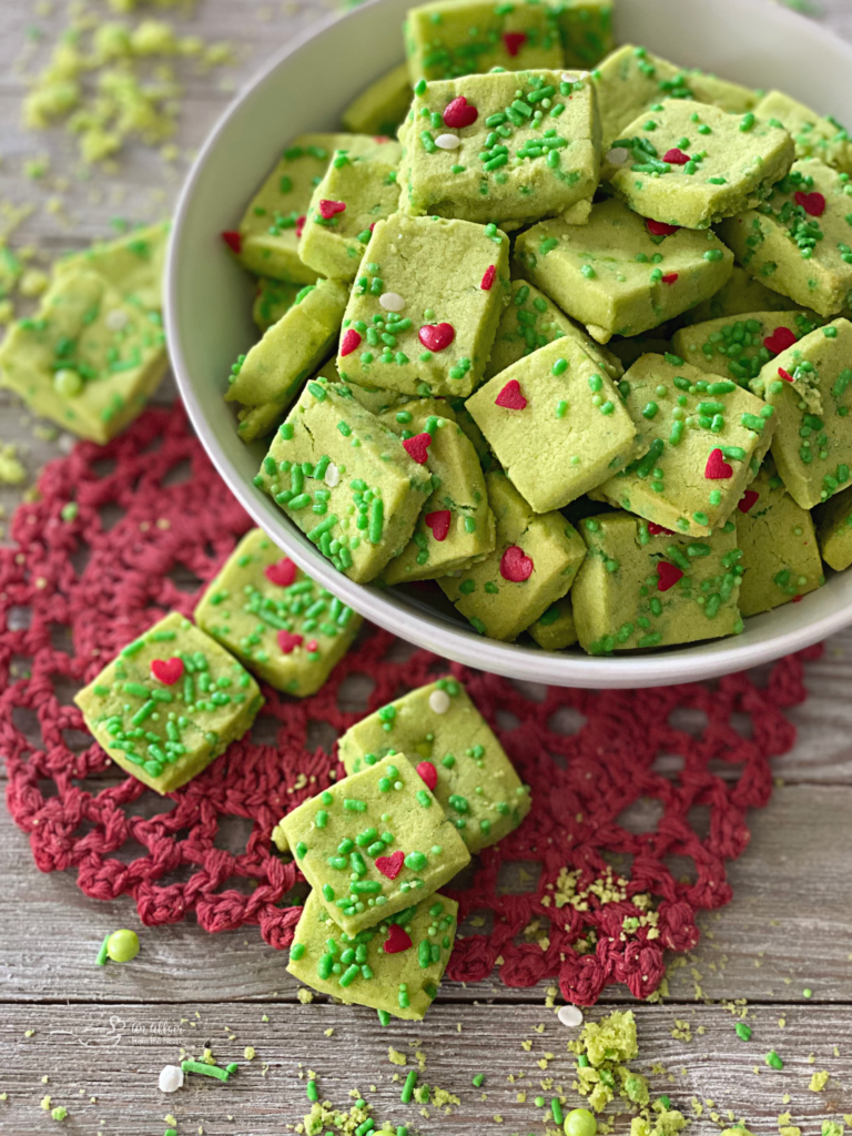 Grinch Shortbread Bites on a red heart shaped doily