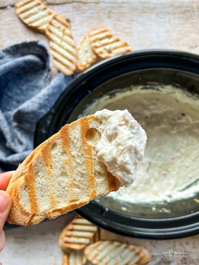 Close up of Slow cooker crab dip on a piece of toast