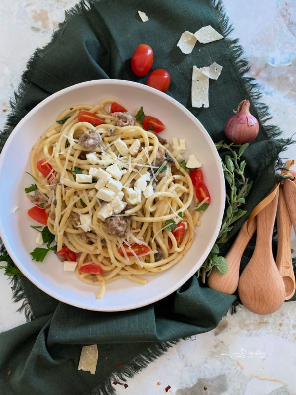 Top view of bucatini pasta with feta and tomatoes