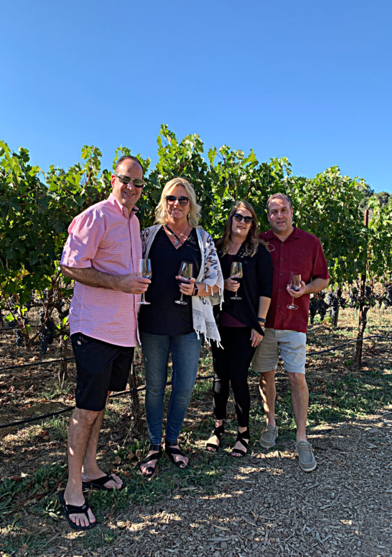 Four people standing in vineyard at Fontanella Winery
