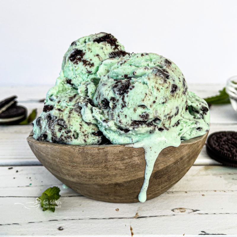 Three scoops of Grasshopper Pie Ice Cream in wooden bowl with Oreos