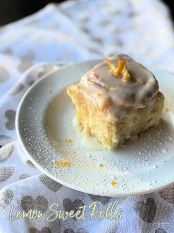 Front view of lemon sweet rolls on white plate