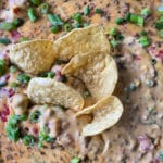 Close up of sausage cheese dip with chips in it