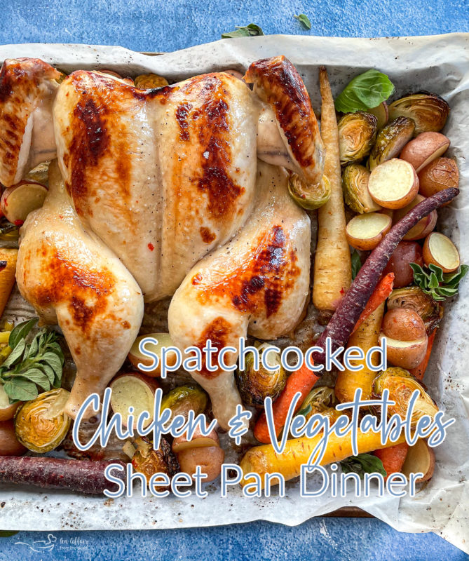 Top view of spatchcock chicken on sheet pan with vegetables
