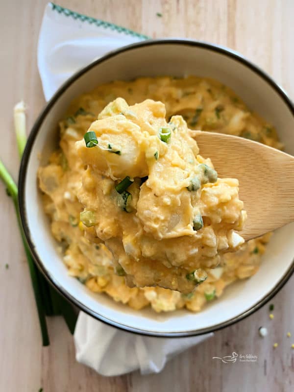 Dorothy's Homemade Potato Salad white bowl light background on spoon